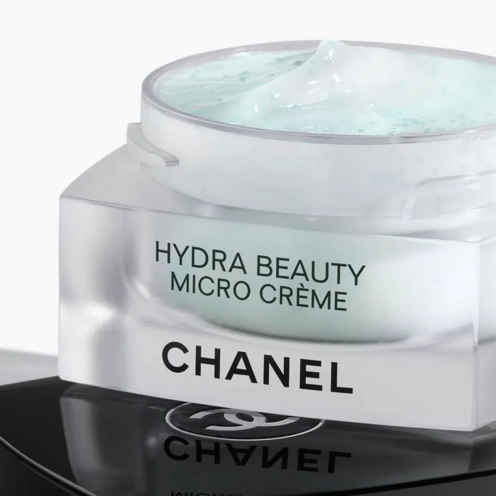 Chanel Hydra Beauty Camellia Micro Crème 50g luxury moisturizer with white camellia flowers on marble surface
