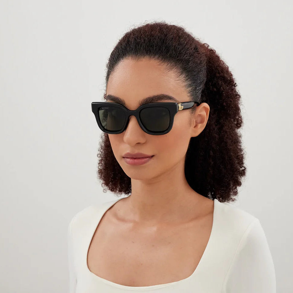 Model wearing GUCCI cat eye sunglasses showing feminine profile
